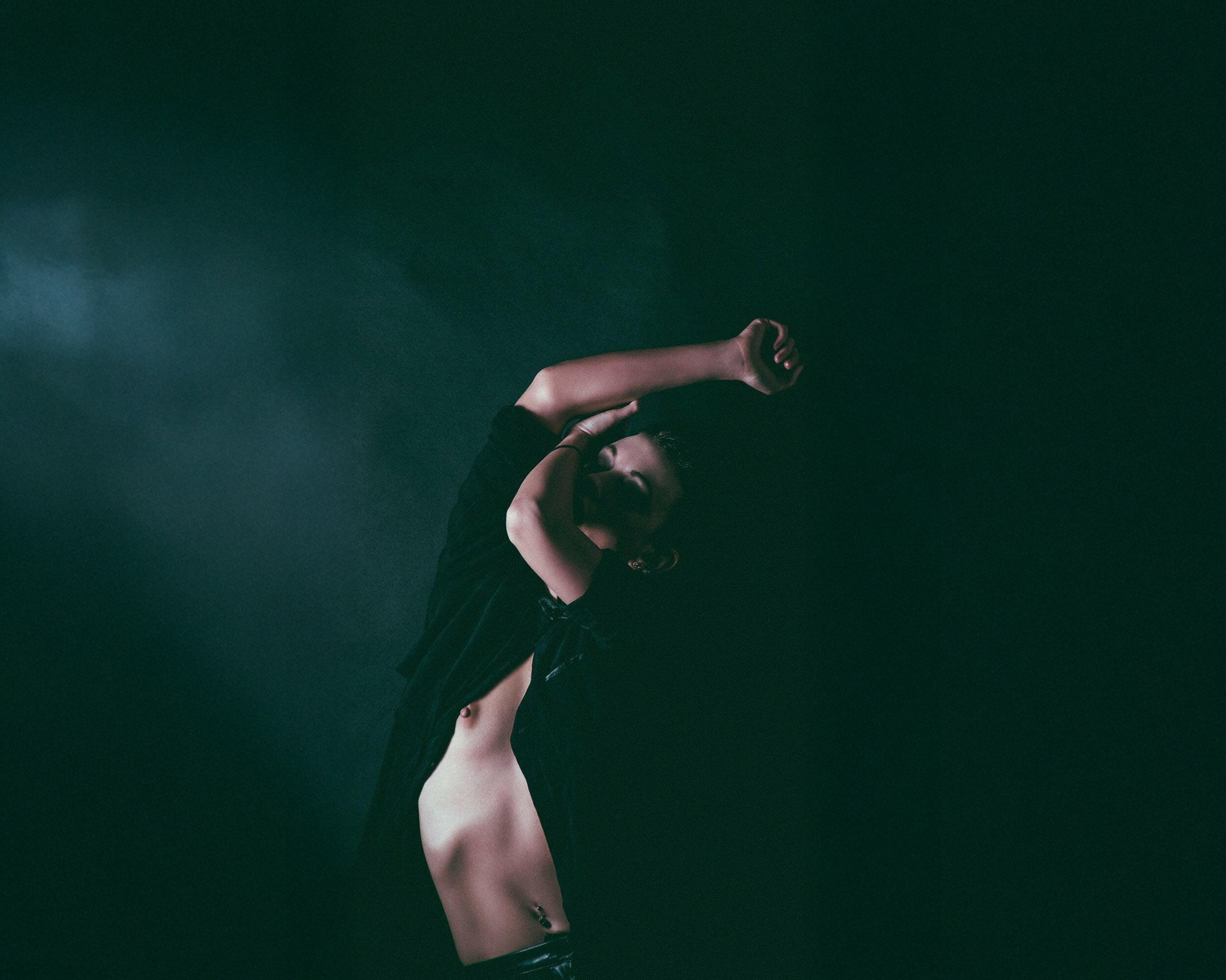 Dancer in a dark setting with dramatic lighting