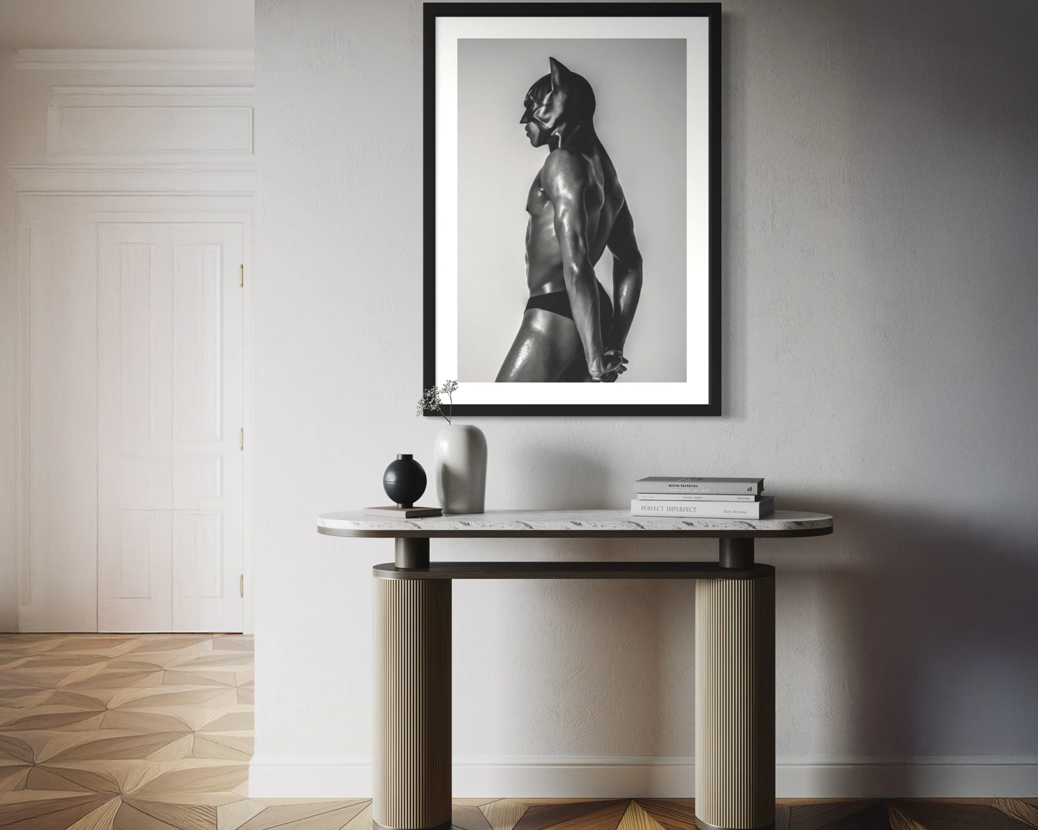 Framed black and white artwork of a panther on a wall above a console table.