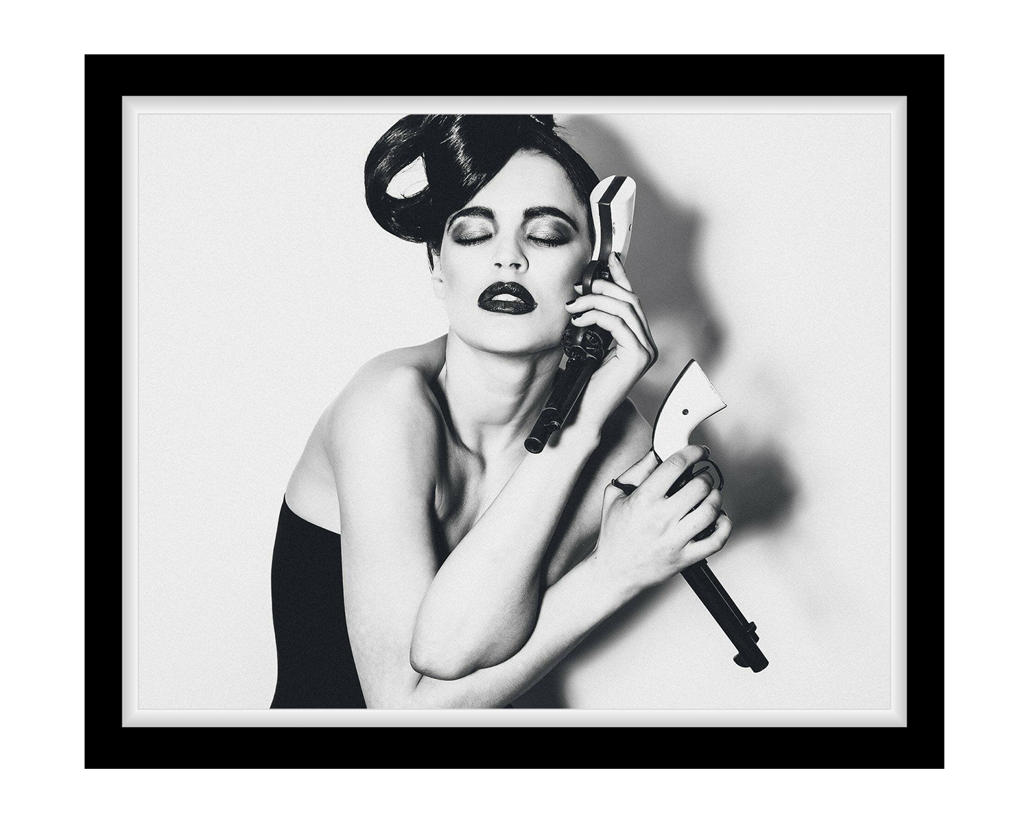 Black and white framed artwork of a woman holding makeup brushes.