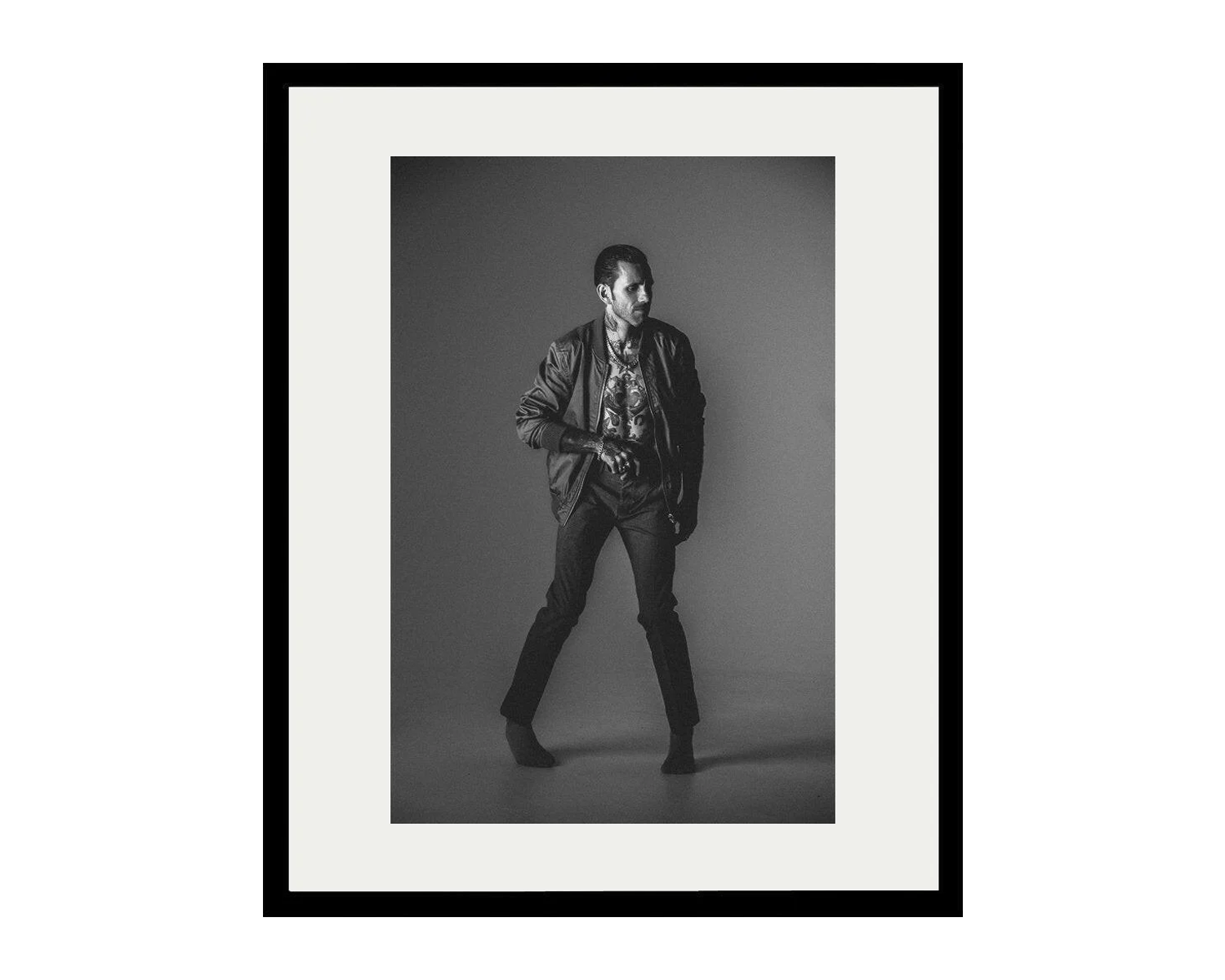 Framed black and white portrait of a person against a dark background