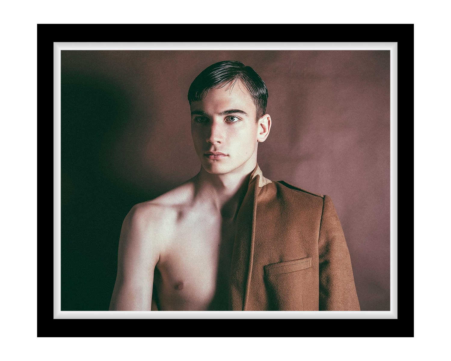 Man wearing a brown jacket against a plain background