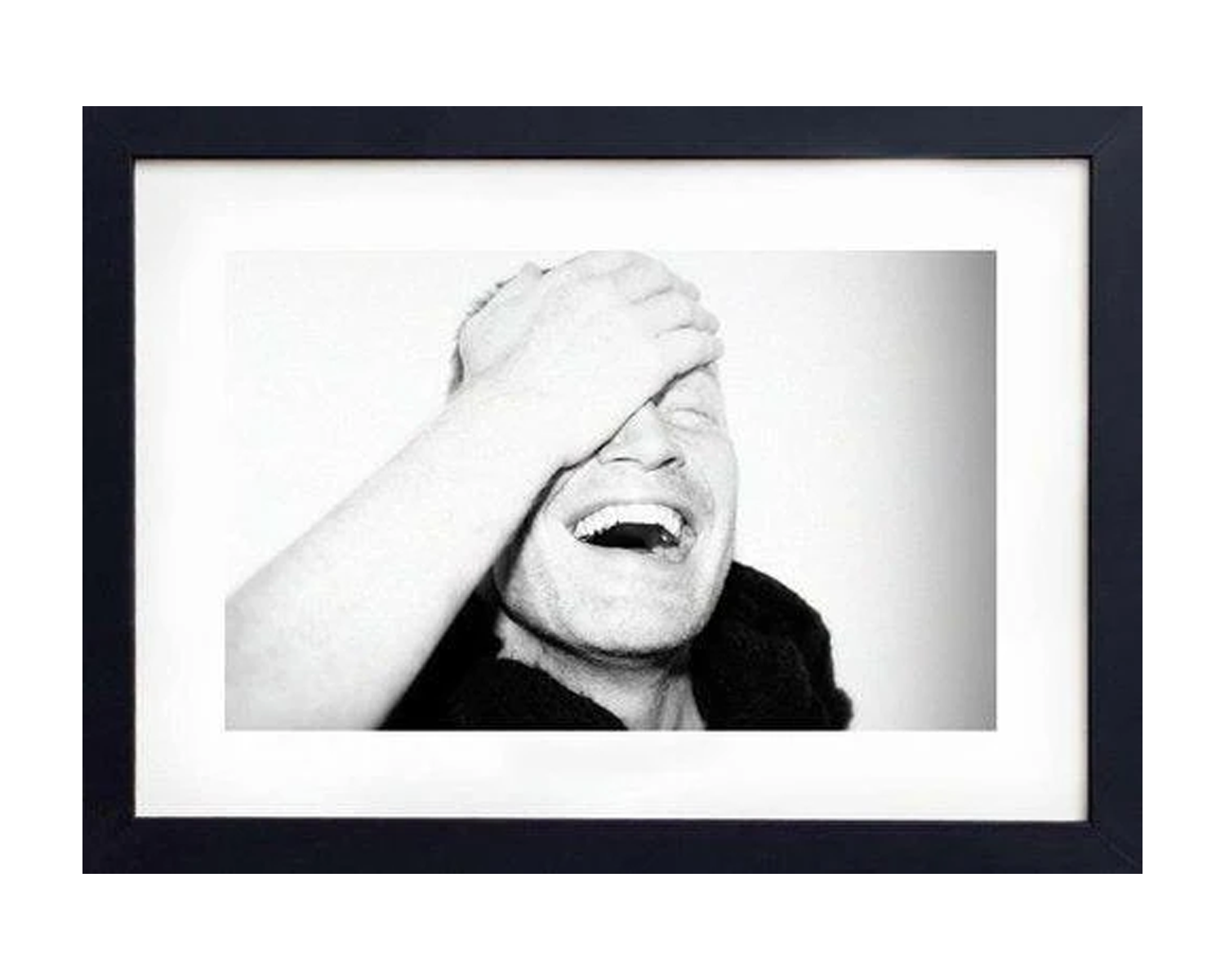 Framed black and white photo of a person with a hand over their face.