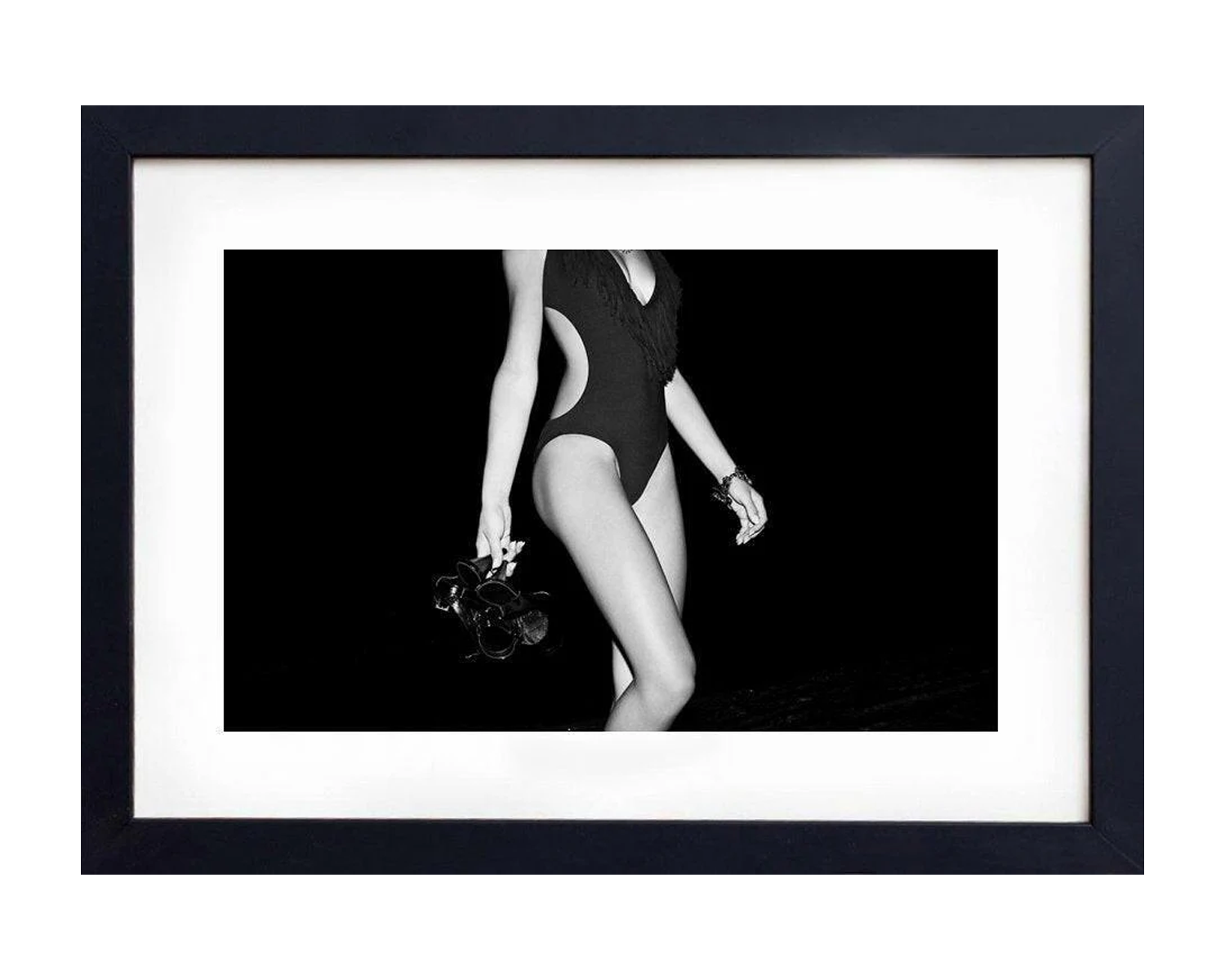 Framed black and white photograph of a girl in a swimsuit against a dark background