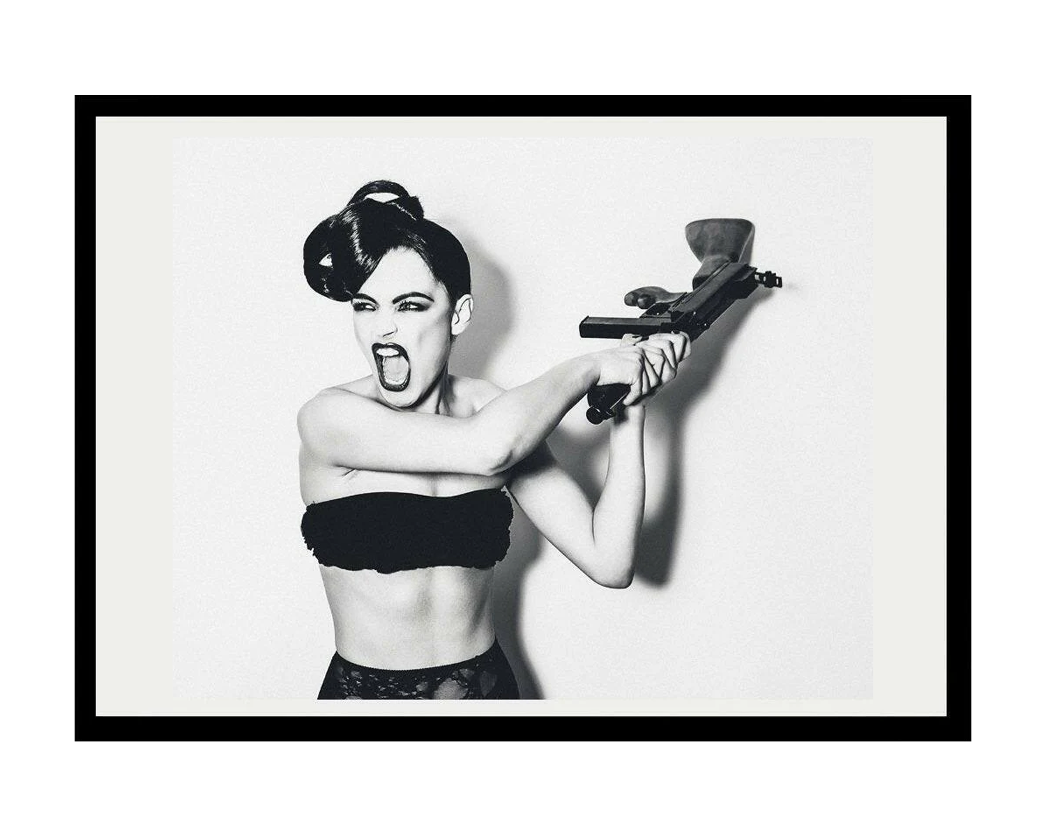 Black and white framed artwork of a woman holding a gun on a white background