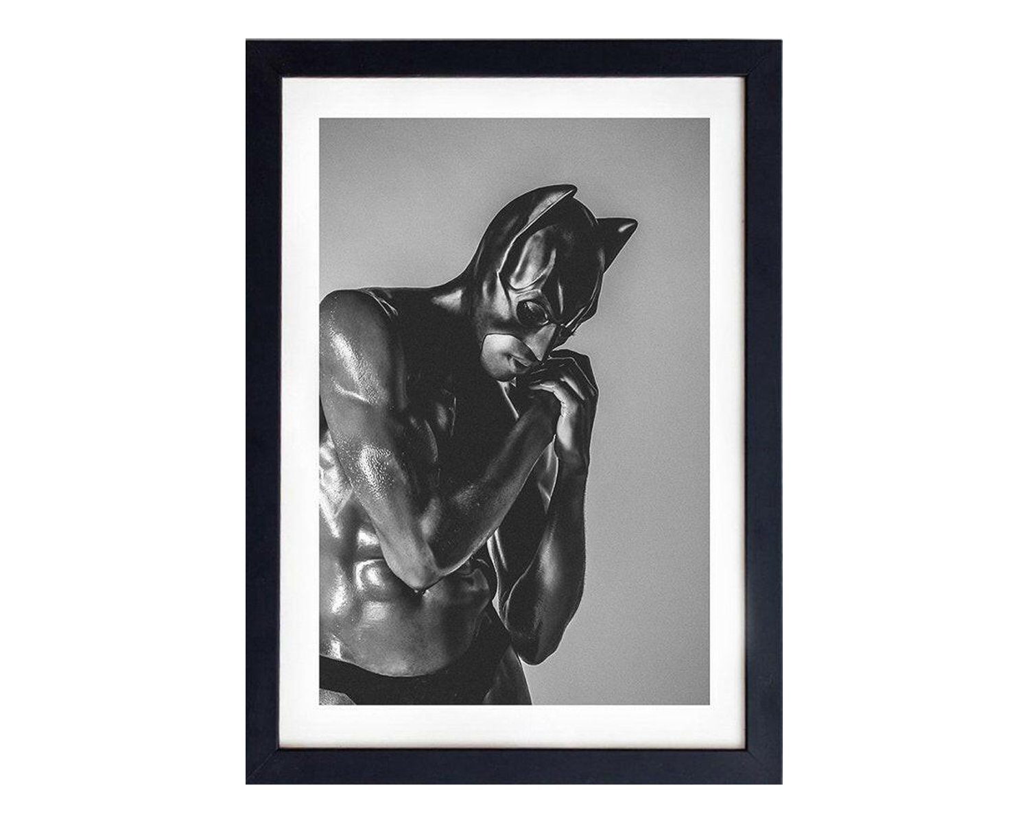 Framed black and white artwork of a muscular figure with a mask.