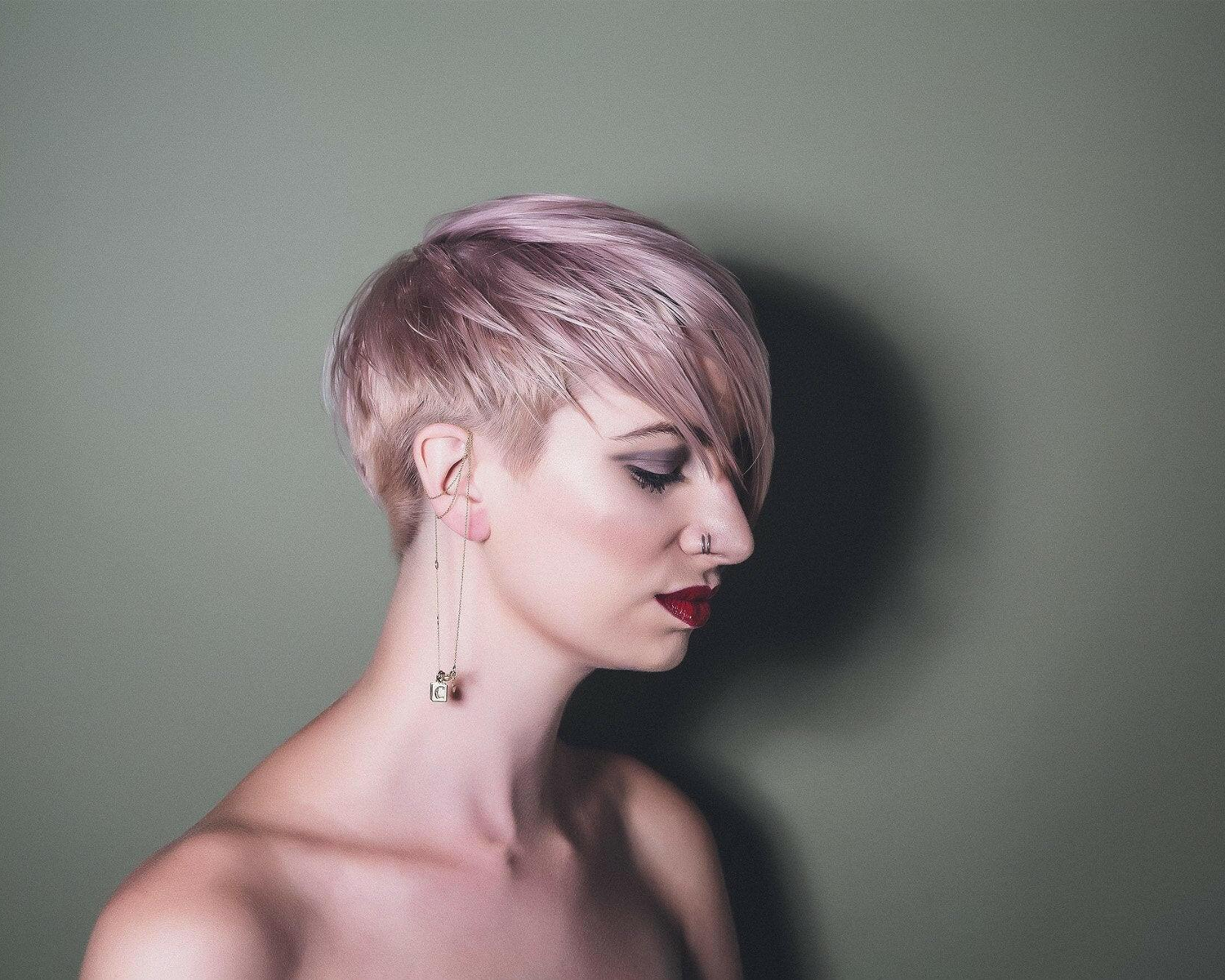 Woman with a short, styled haircut against a plain background