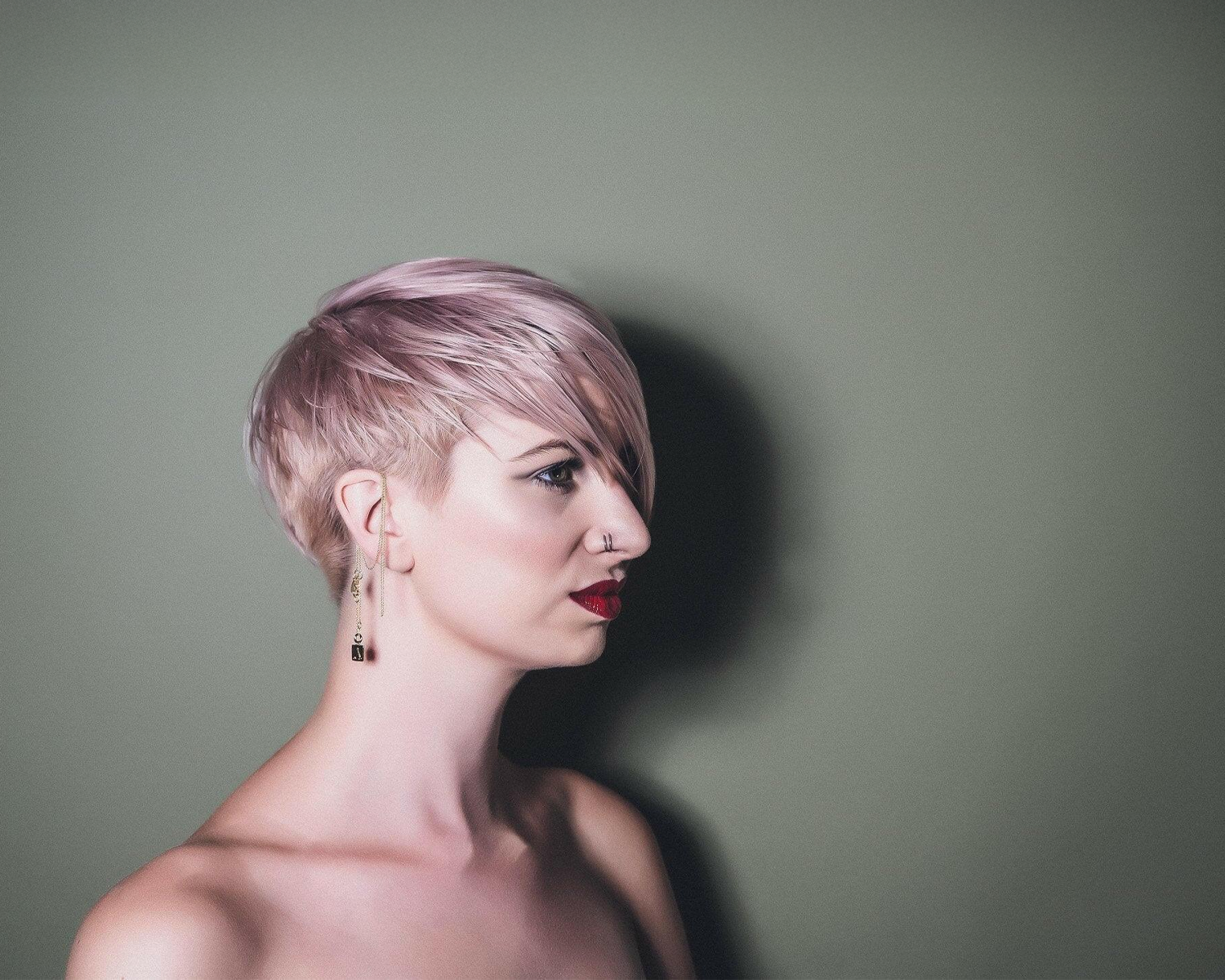 Woman with short, styled hair against a plain background