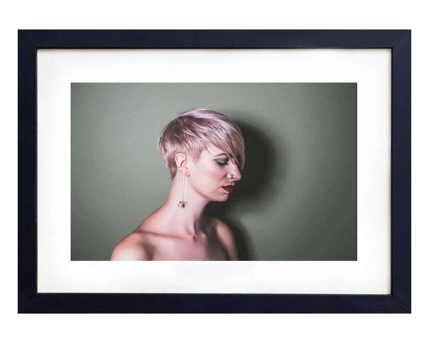 Framed portrait of a lady with short hair against a plain background