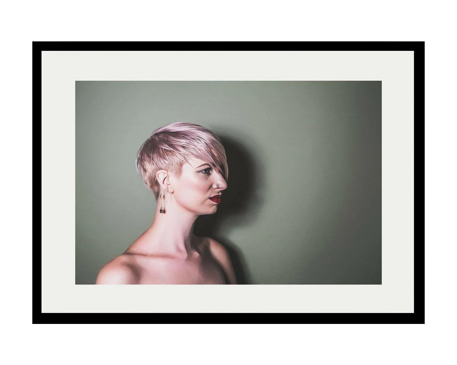 Framed portrait of a girl with short hair on a plain background