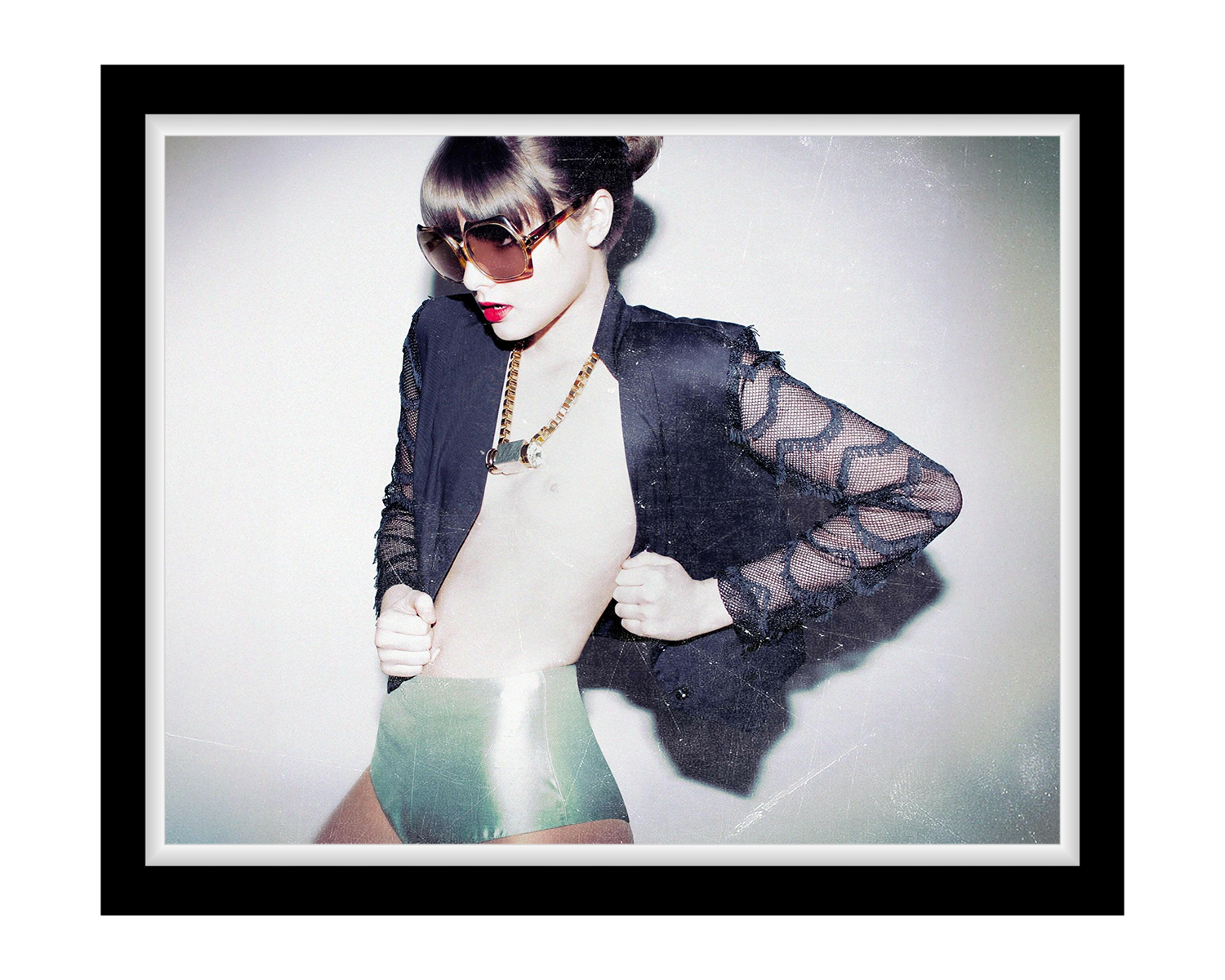 Girl wearing a sheer black top over a white outfit with sunglasses and red lipstick.