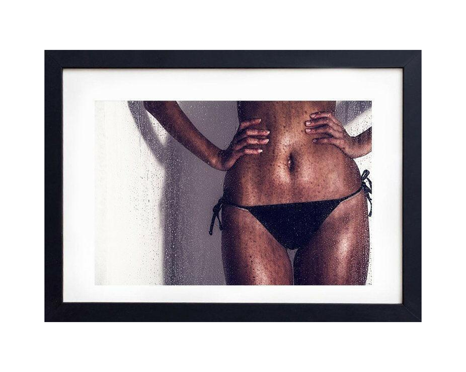 Framed photograph of a lady wearing a black bikini bottom.
