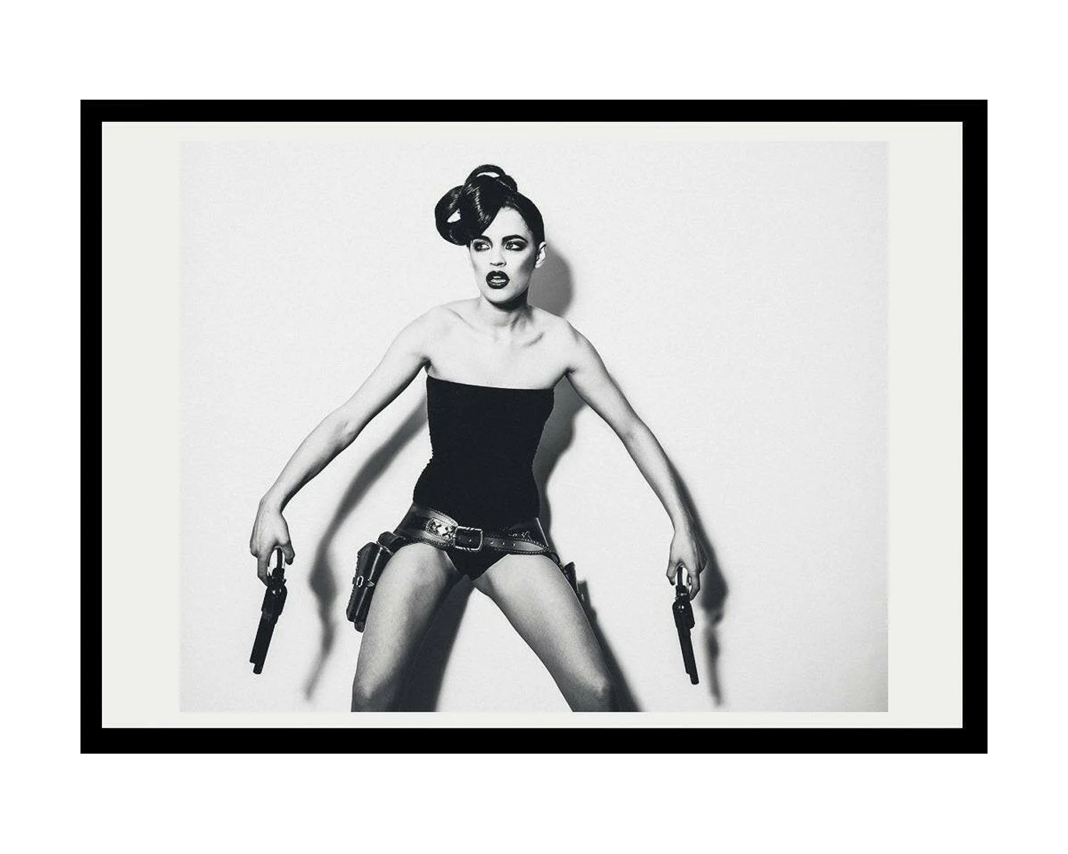 Framed black and white art print of a stylized woman with a gun on a white background