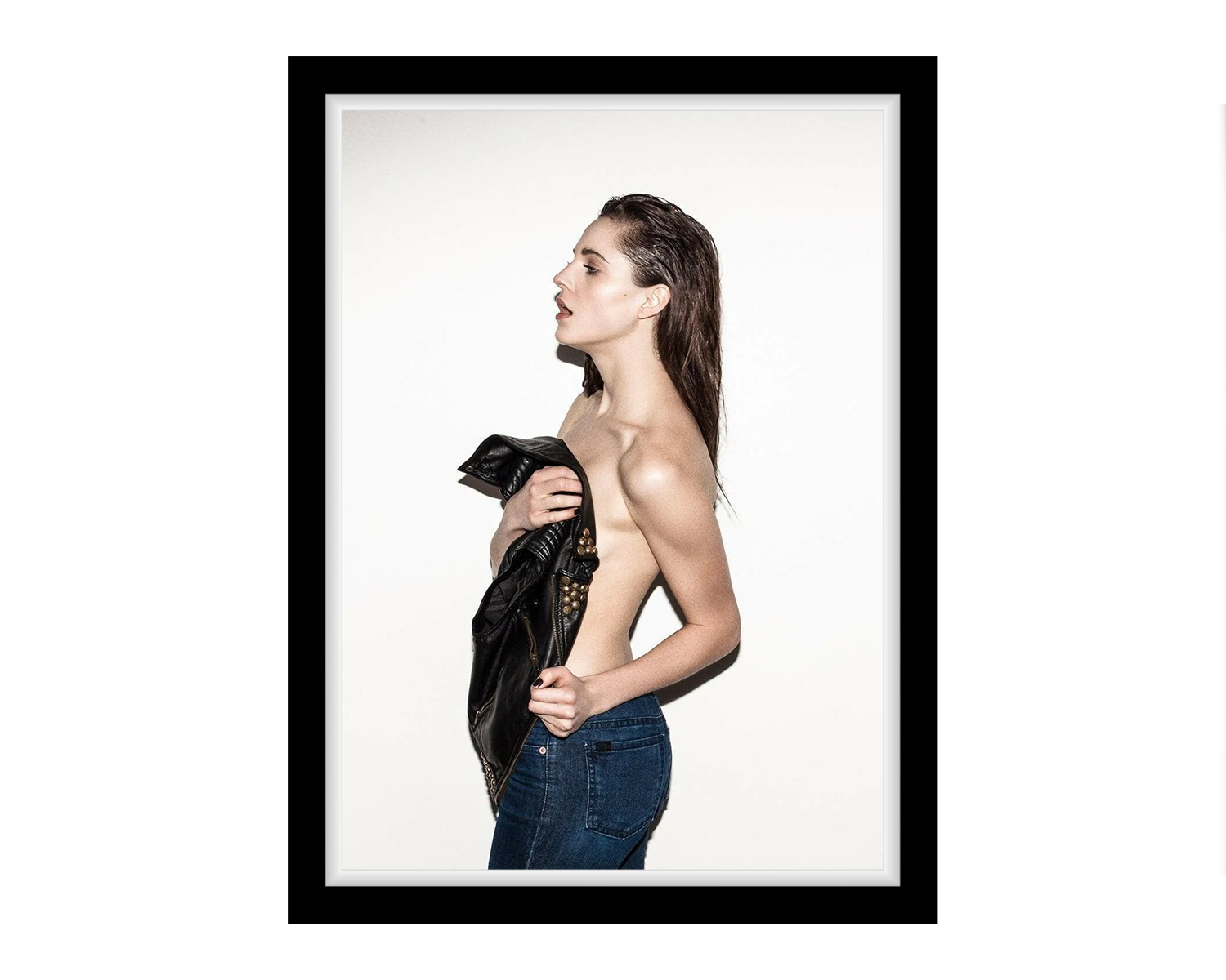 Framed photograph of a woman holding a black garment against a white background
