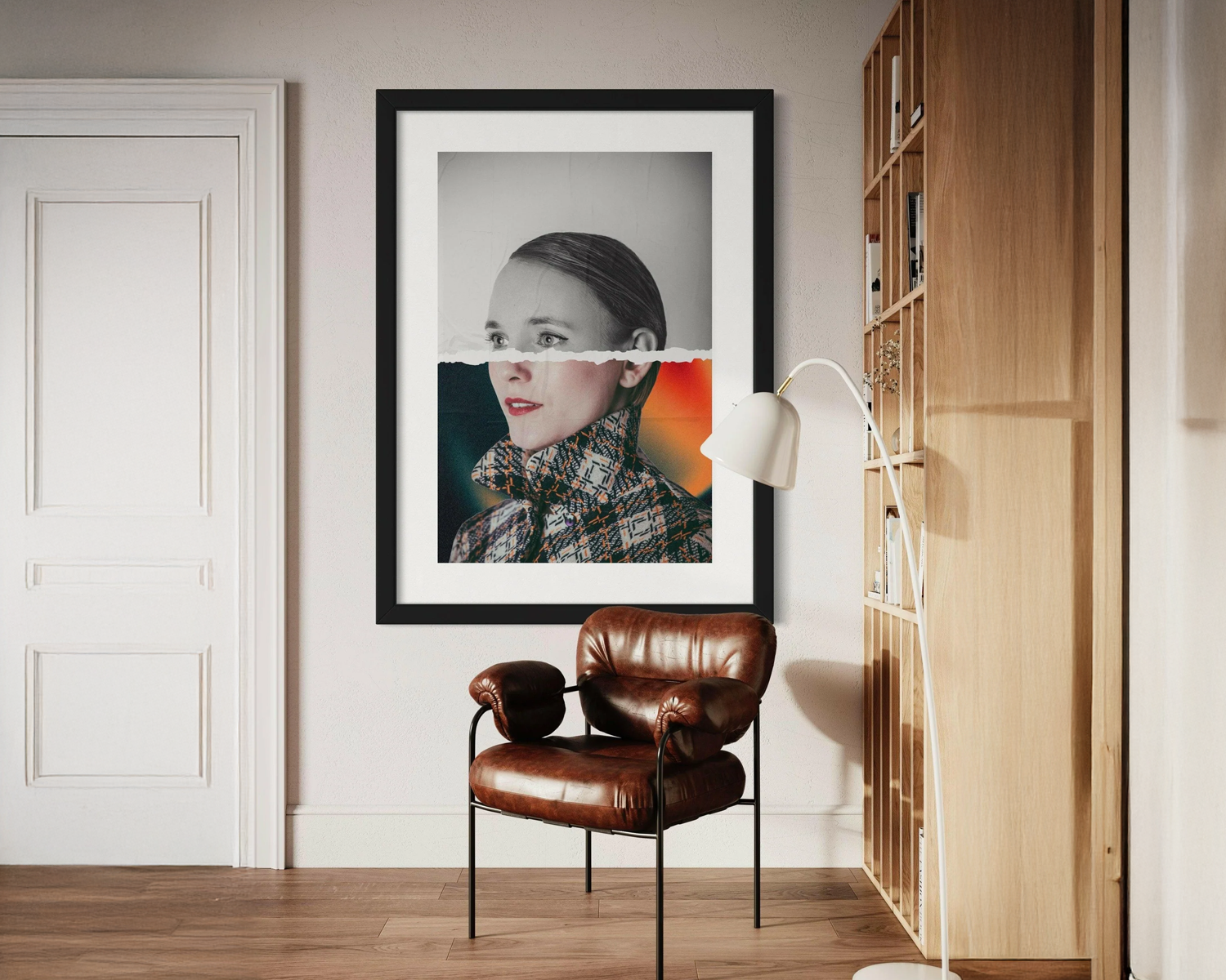 Framed portrait on a wall above a brown leather chair in a room with wooden floor and bookshelf.
