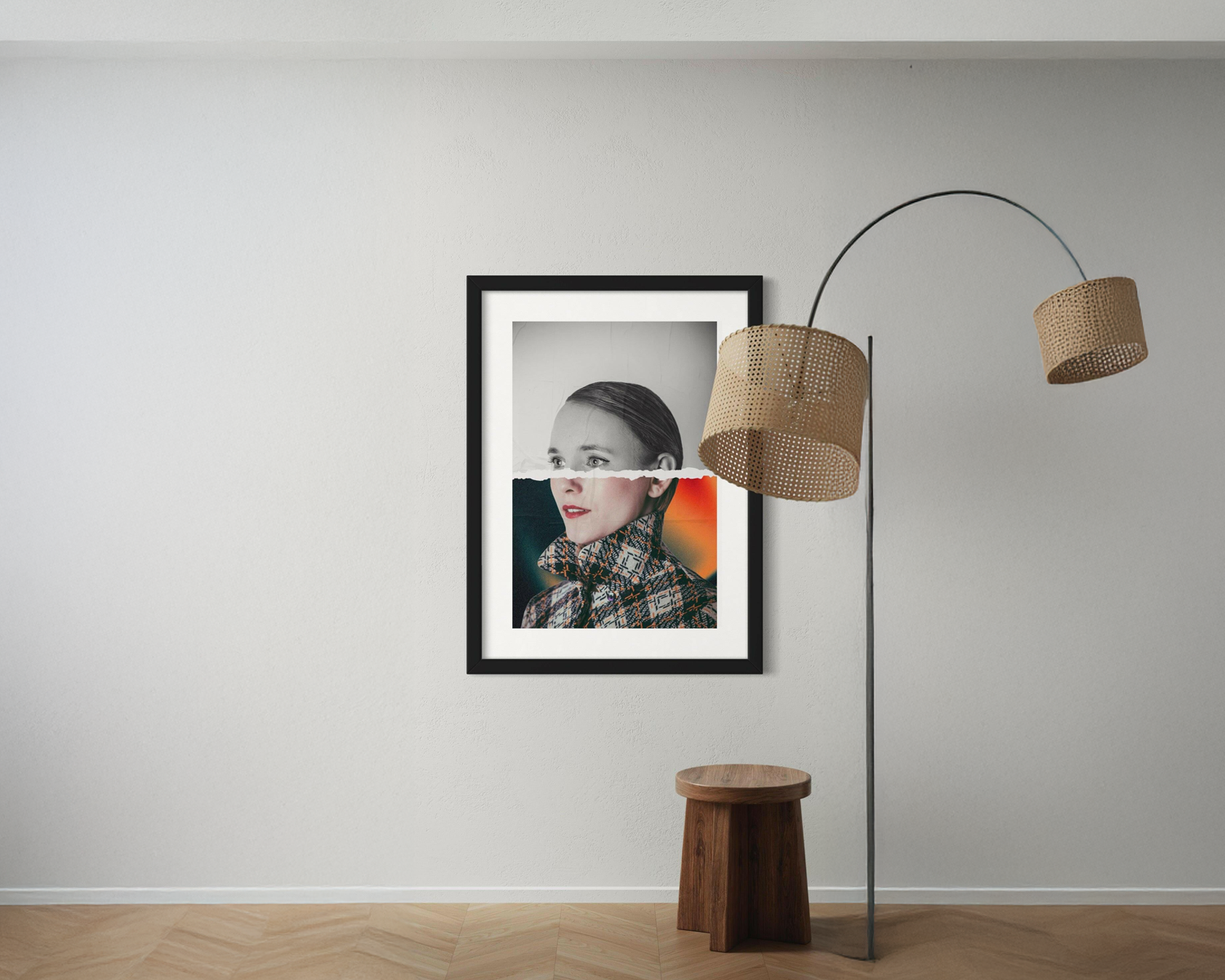 Framed artwork on a wall with a floor lamp and wooden stool in a room.