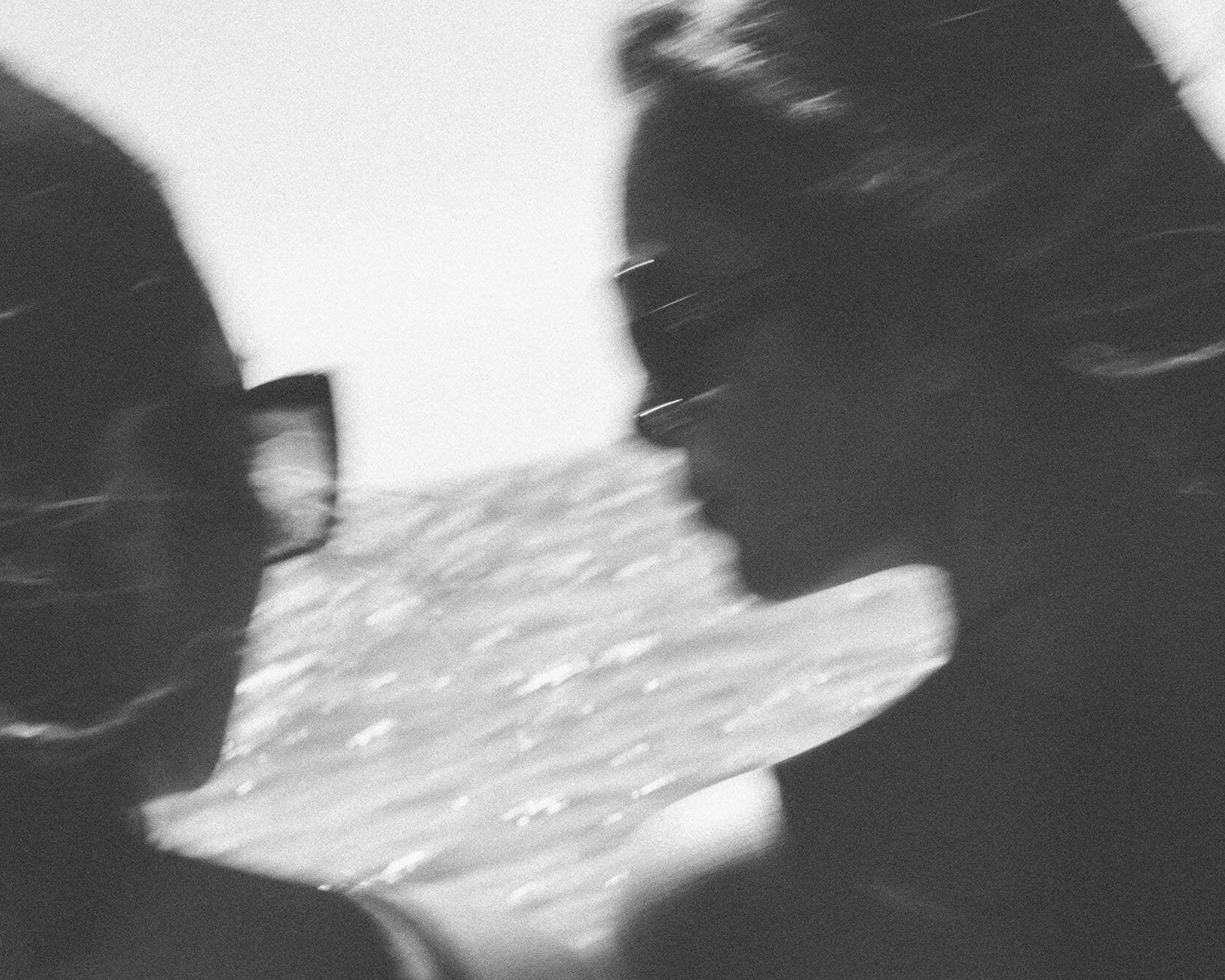 Black and white photo of 2 ladies holding a phone with a blurred background